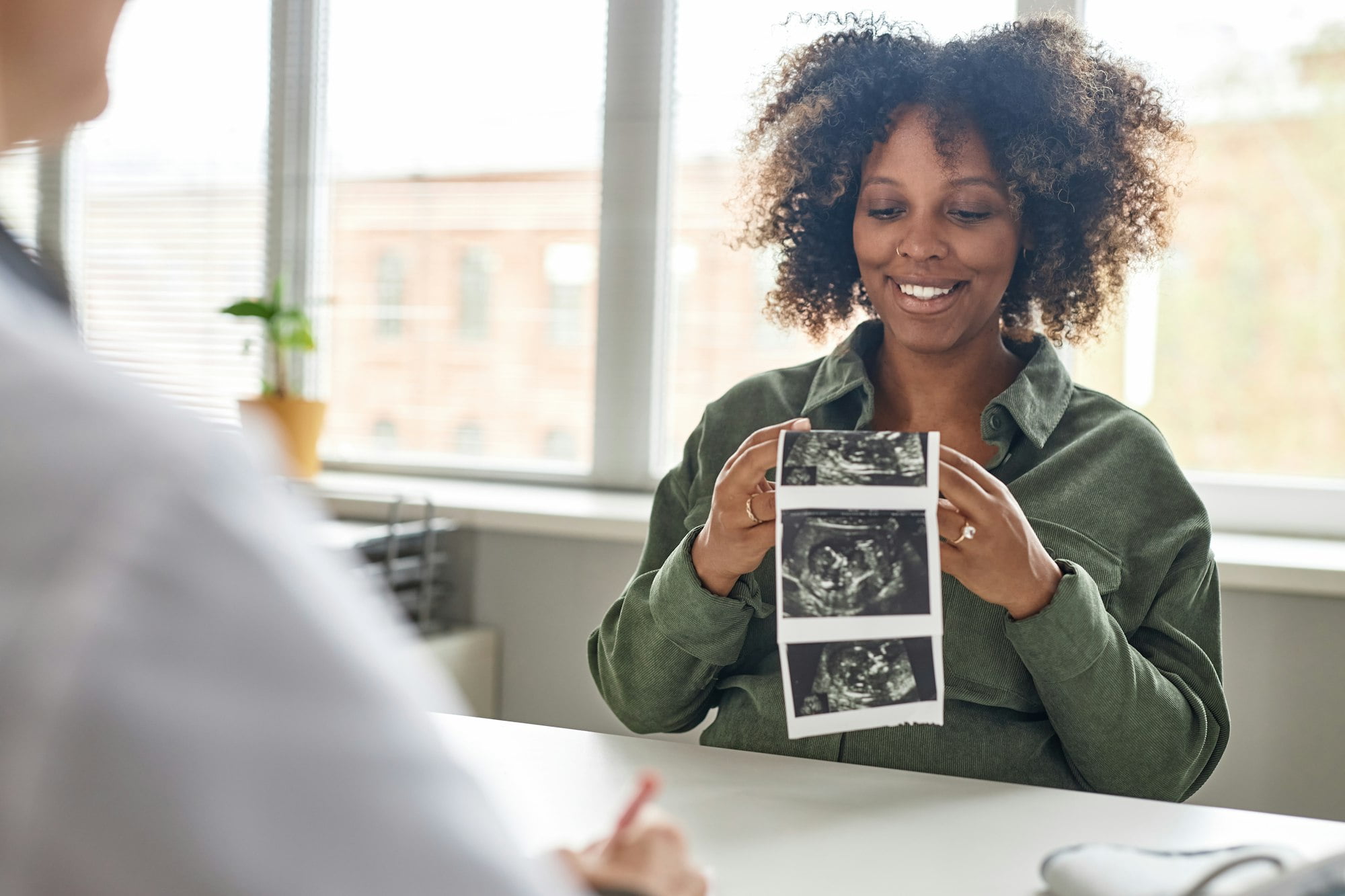 Happy Pregnant Woman Holding Ultrasonography Picture