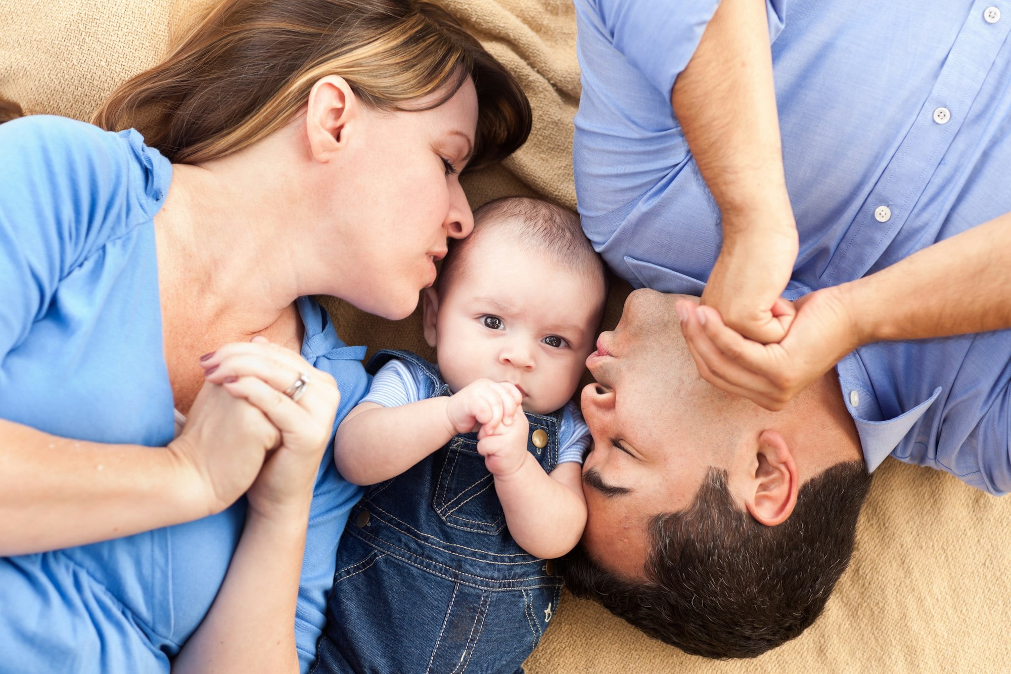 Mixed Race Family with Baby Playing on the Blanket